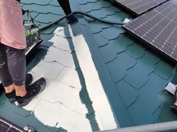 青から深緑に塗り替える屋根の1回目の上塗り
